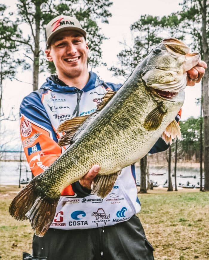 Professional angler Grae Buck holding up a giant largemouth bass